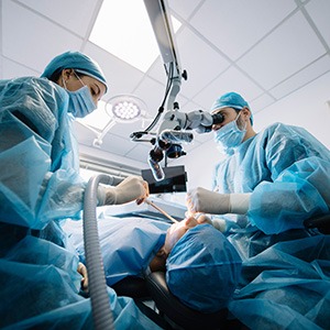 Dentists performing a dental implant surgery